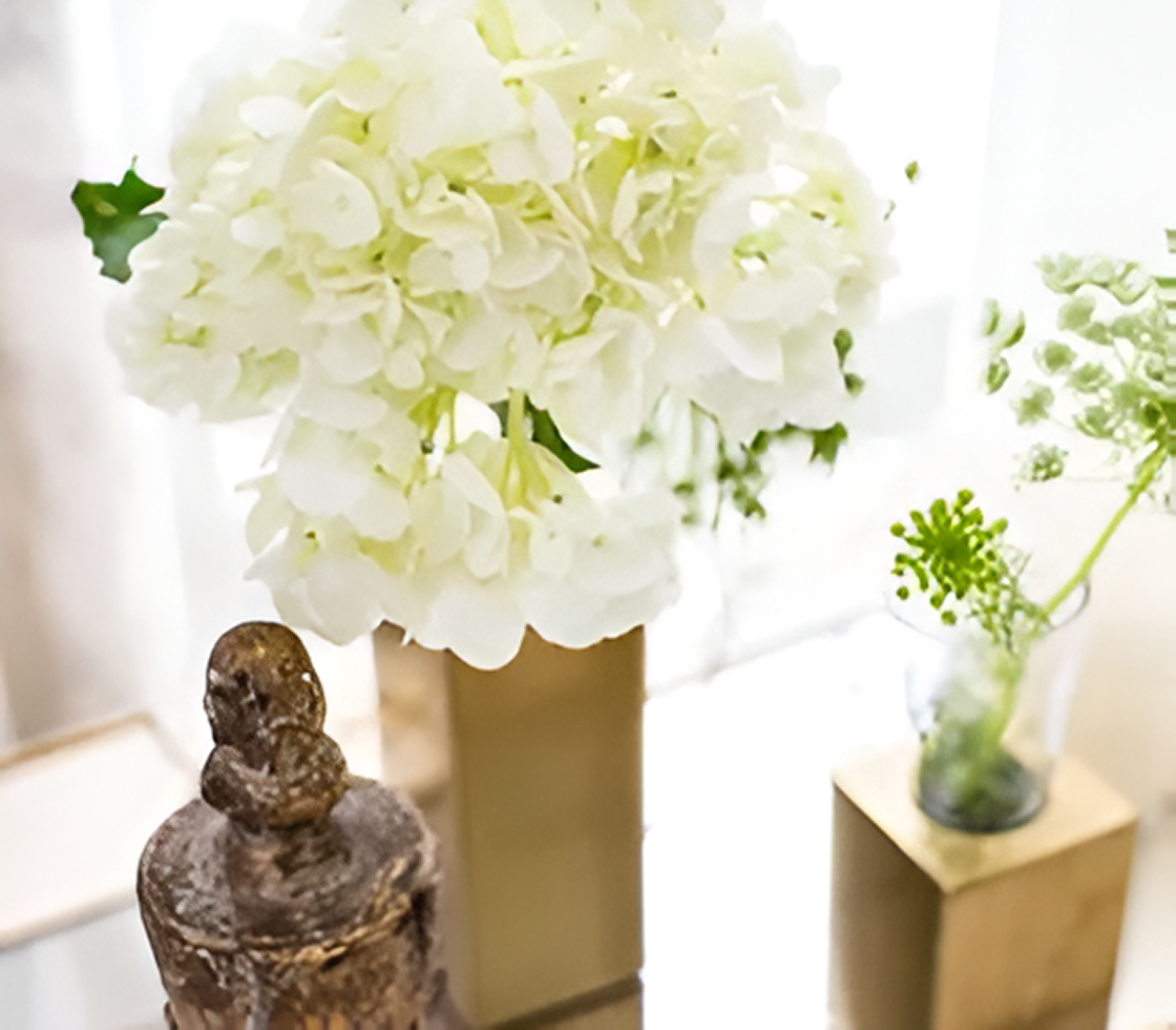 Elegant floral arrangement with statue
