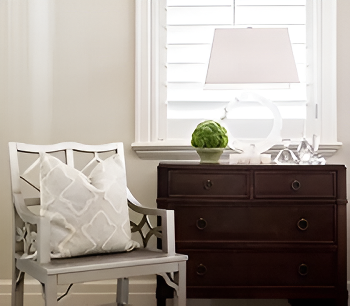 Chair and dresser by window
