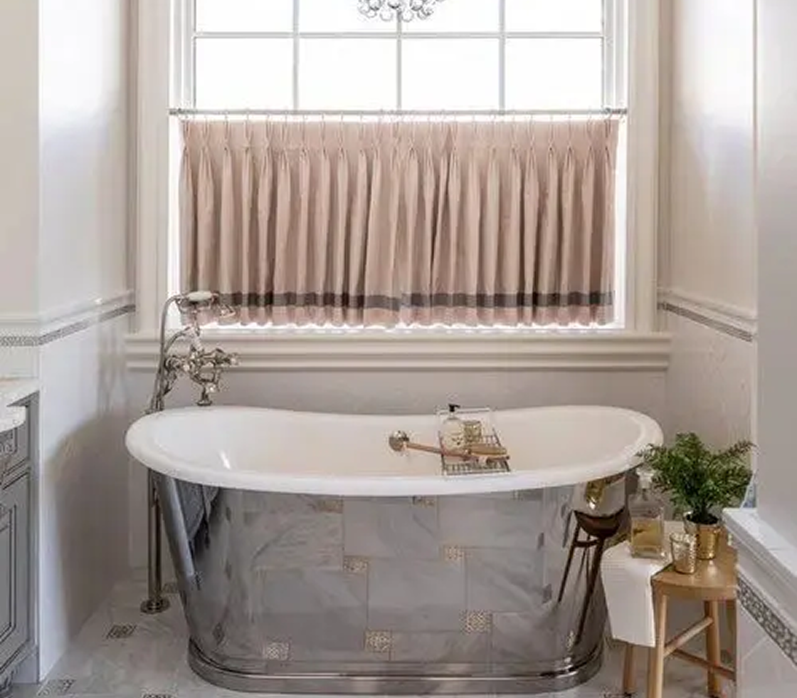 Elegant bathroom with freestanding silver bathtub.